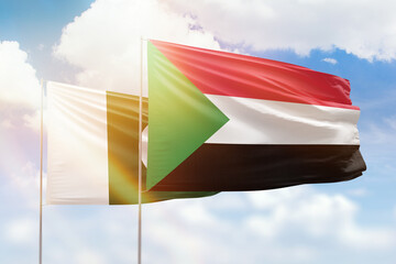 Sunny blue sky and flags of sudan and pakistan