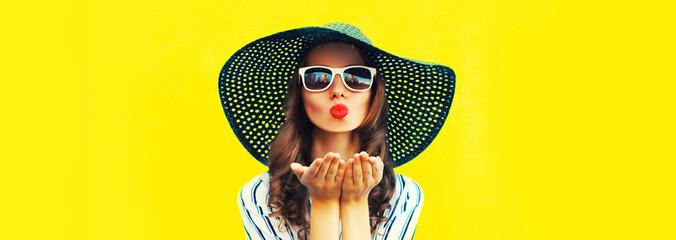 Portrait of beautiful young woman blowing her lips sending air kiss wearing sunglasses, summer...