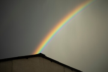 Rainbow in sky. Beautiful weather. Decomposition of light into colors.
