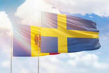 Sunny blue sky and flags of sweden and moldova