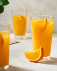 summer snack with three orange juice and cut slices to eat