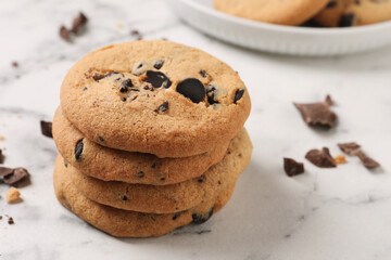 Delicious chocolate chip cookies on white marble table. Space for text