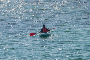 man in canoe on the sea in summer