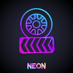 Glowing neon line Car tire wheel icon isolated on black background. Vector