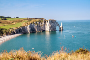 Etretat Aval cliff, rocks and natural arch landmark and blue ocean. Aerial view. Normandy, France, Europe.