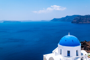 Blue dome church and the Sea in Oia, Santorini, Greece, Aegean Sea.