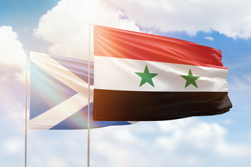 Sunny blue sky and flags of syria and scotland