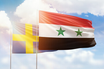 Sunny blue sky and flags of syria and sweden