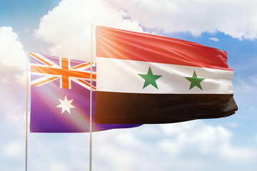 Sunny blue sky and flags of syria and australia