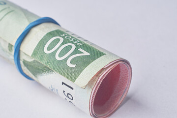 Mexican money, Mexican pesos bills and coins on white background.