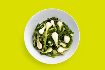 Pickled spring onion in white bowl