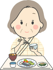 入院食を食べるシニア女性2