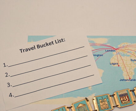 White Travel Bucket List, Partial Map of Airline Routes, Partial View of Souvenir Bracelet from Paris