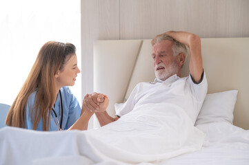 Home care and healthy insurance. female doctor embracing encouraging happy senior male patient in hospital.