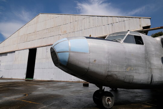 Vintage aircraft in front of hangar