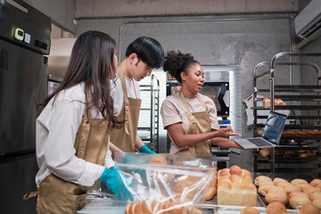 Three young friends and startup partners of bread dough and pastry foods busy with homemade baking...