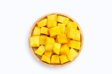 Yellow mango cube slices in wooden plate