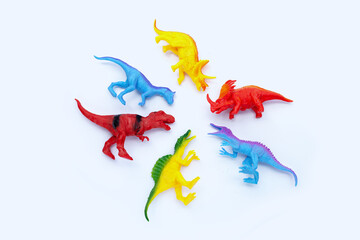 Plastic dinosaur toys on white background. Top view