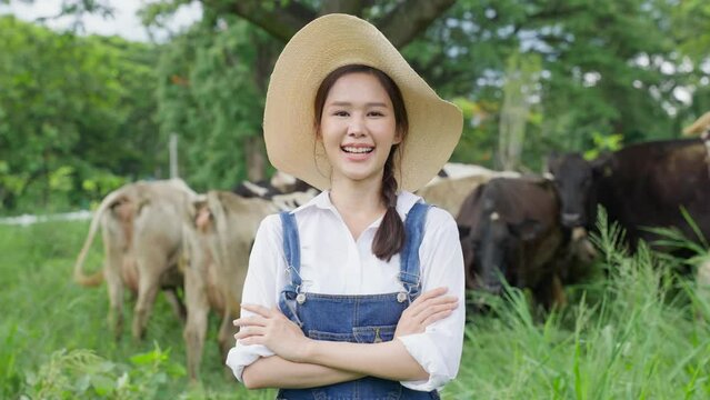 Portrait of Attractive Asian dairy farmer woman work outdoor in farm.
