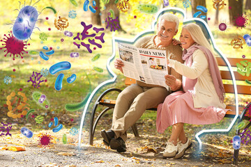 Loving mature couple reading newspaper in autumn park. Concept of strong immunity