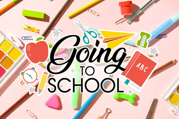 Text GOING TO SCHOOL and set of stationery on pink background