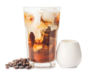 Glass of cold brew, coffee beans and milk on white background