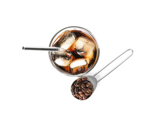 Glass of cold brew with straw and spoon with coffee beans on white background