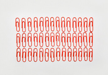 Red paper clips on light background