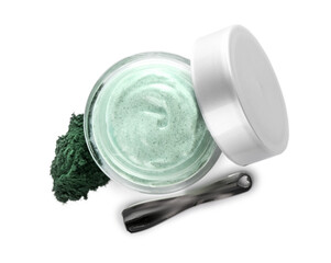 Jar of spirulina facial mask and spatula on white background