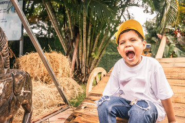 Rancher boy screaming on a farm in Latin America outdoors - obrazy, fototapety, plakaty