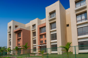 Obraz premium New residential building complex being built at Rajarhat New Town area of Kolkata, West Bengal, India. It is one of the fastest growing cities in eastern region of India. Blue sky background.