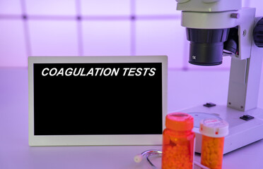Medical tests and diagnostic procedures concept. Text on display in lab Coagulation Tests