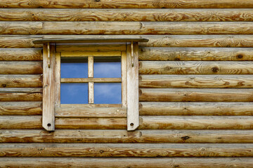 Background in the form of a fragment of an authentic wooden house in the form of a window with a wooden frame.