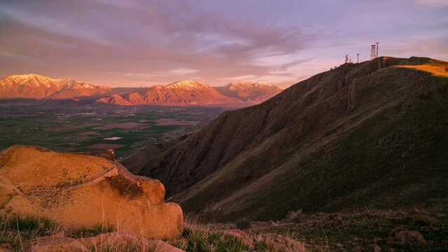 Sunset timelapse as light moves over mountain range from other mountain top in Utah.