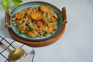 a plate of stir fry tofu with vegetables 