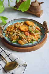 a plate of stir fry tofu with vegetables 