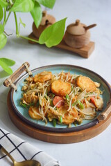 a plate of stir fry tofu with vegetables 