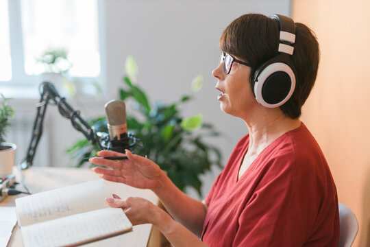 Middle-aged Female Radio Presenter Talking Into The Microphone And Reading News - Radio Broadcast Online Concept