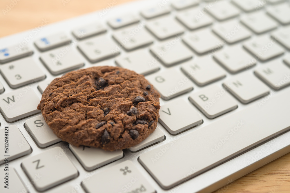 Wall mural chocolate chip cookies on keyboard computer background copy space. cookies website internet homepage