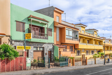 Fototapeta na wymiar San Cristobal de La Laguna, Spain - November 24, 2021: Bright old buildings on Calle Pedro Zerolo street in La Laguna town on the Tenerife island. Colorful cityscape in the Canary Islands