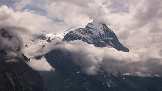 Timelapse of dynamic cumulus clouds in front of moench and eiger north face in Swiss Alps