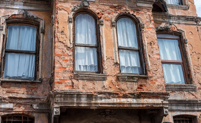 old cracked brick wall with a window. architecture, details.