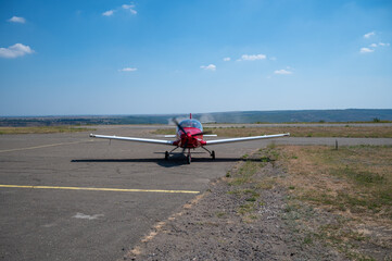 Light aircraft taxis on the runway at the airport