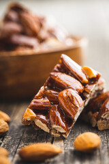 Sweet mini almond bars on wooden table.