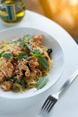 Italian cuisine. Pasta with parmesan and basil on a sunny background