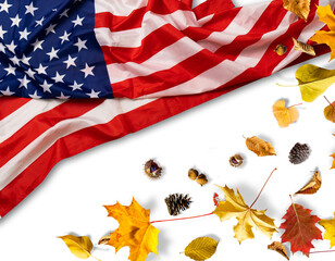 USA flag buried in yellow dry leaves. Autumn texture
