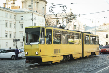 Naklejka na ściany i meble Yellow tram in Lviv city in sunny day