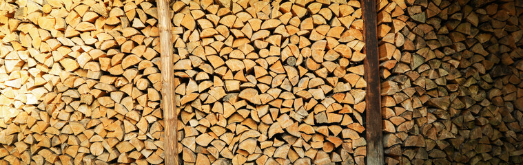 Background of dry chopped firewood logs in a pile