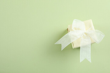 Gift box on green background, space for text