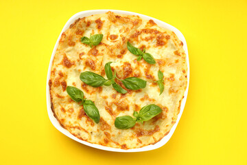 Delicious Lasagna on yellow background, top view